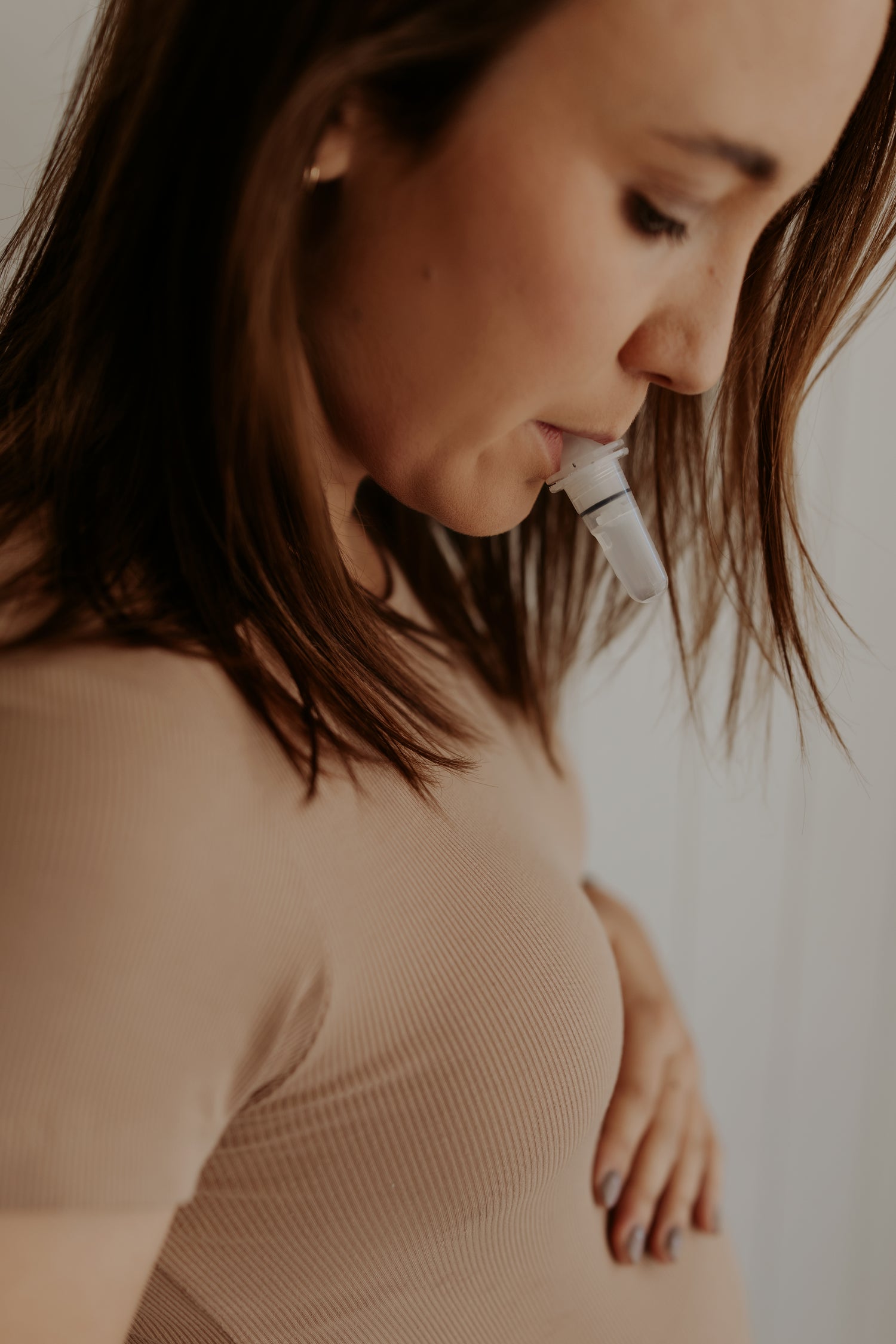 "Pregnant woman using the WinnerFlow breathwork device in her mouth, exclusively available through The Birth Teacher Australia"