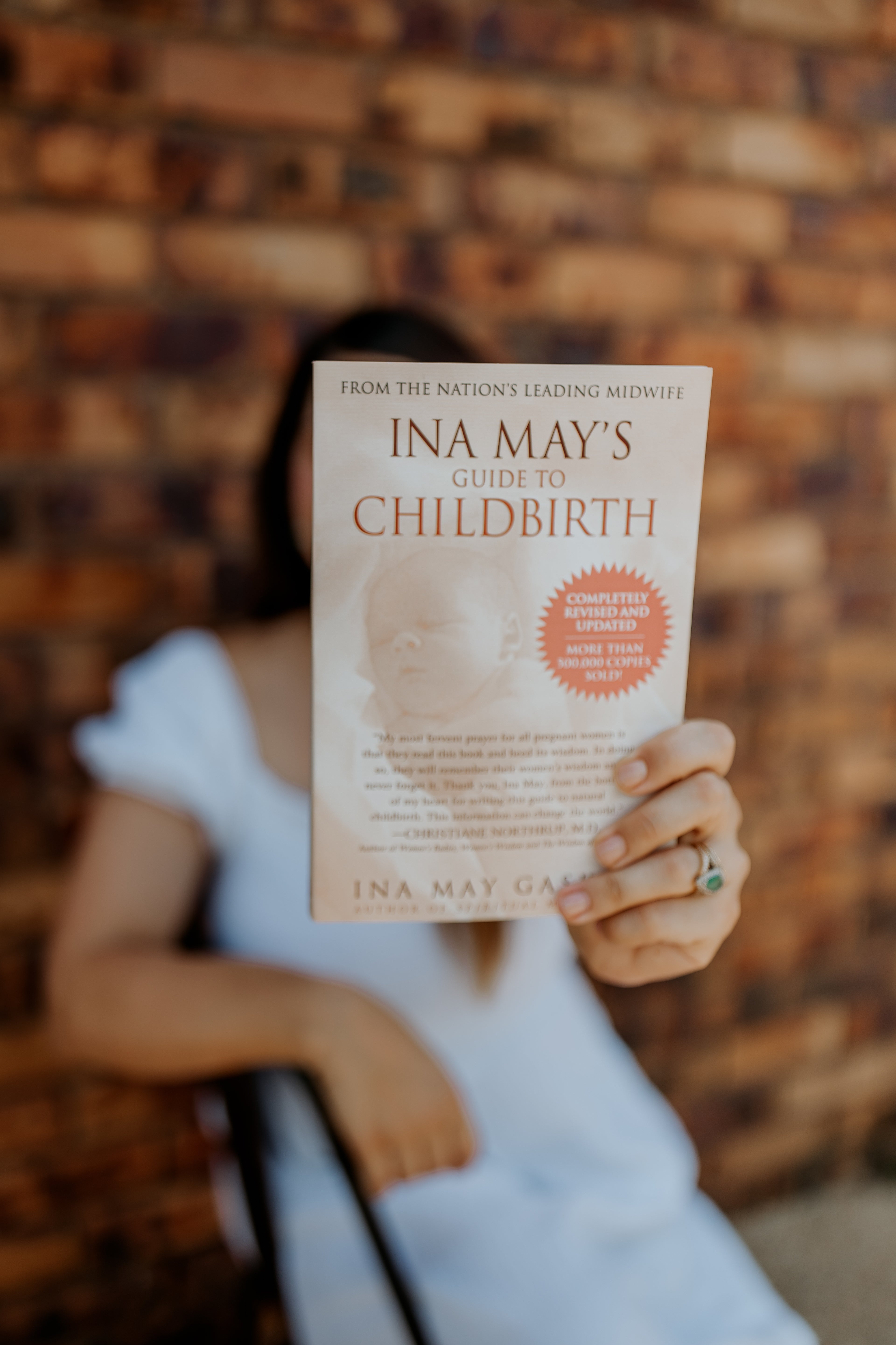 "The Birth Teacher holding a childbirth education book, supporting expectant parents in Emerald QLD, Australia"