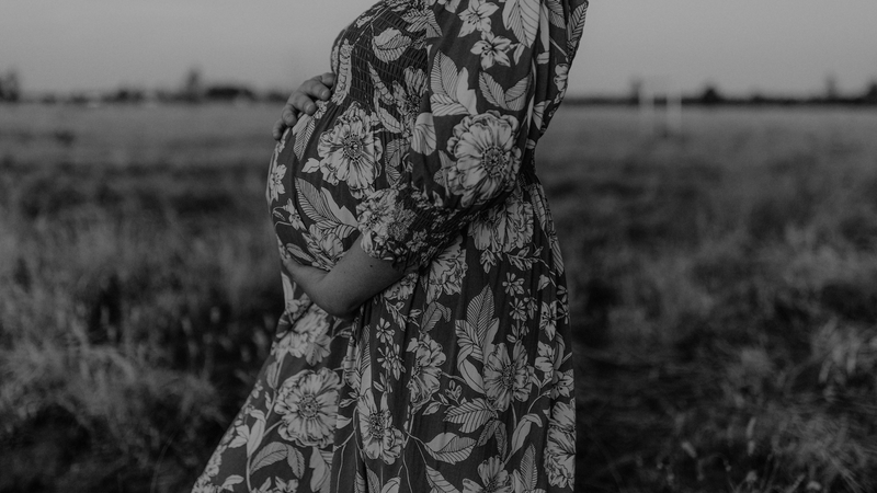 "Pregnant woman gently holding her belly, representing maternal care with The Birth Teacher in Emerald QLD, Australia"