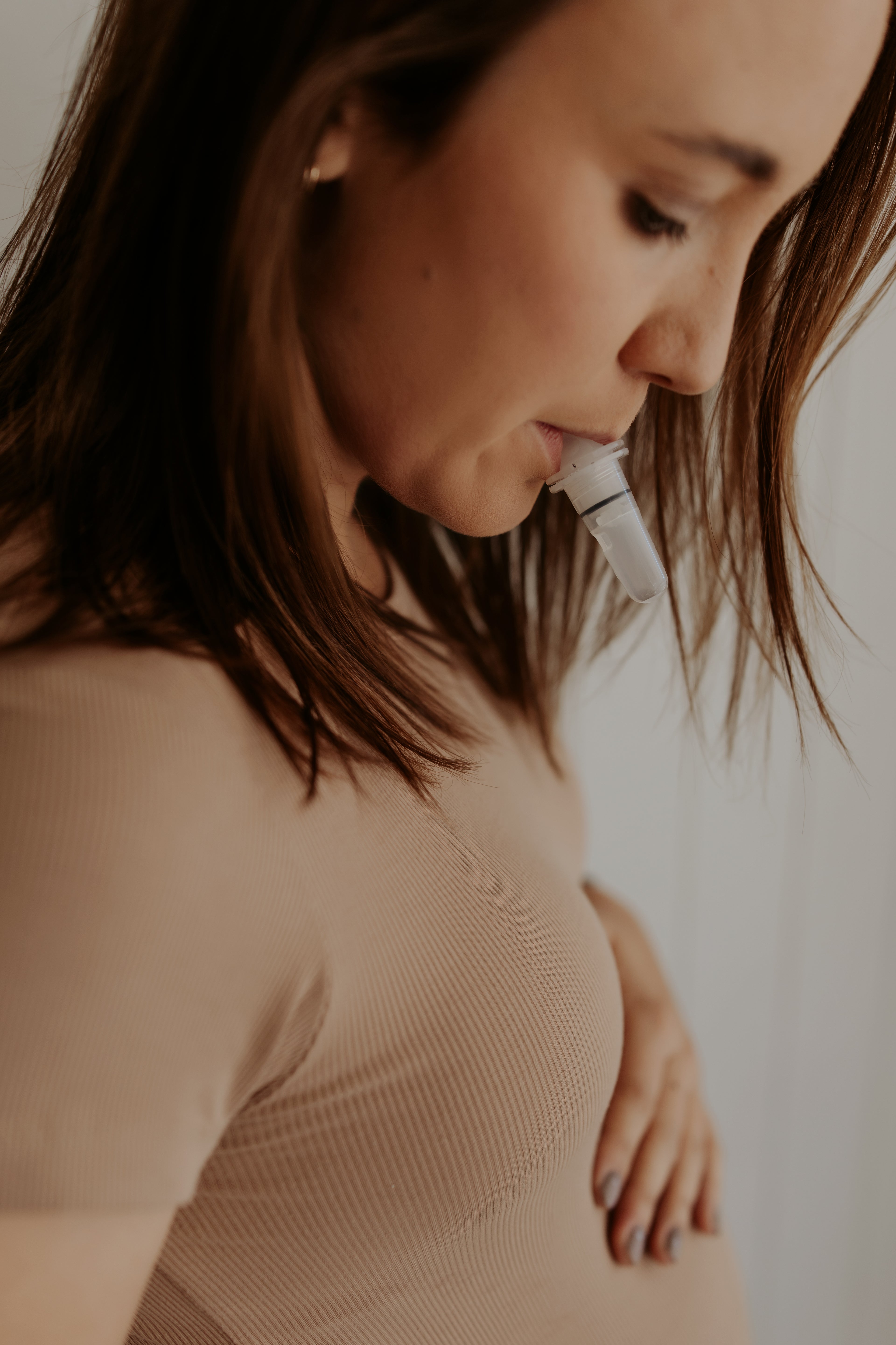 &quot;Pregnant woman using the WinnerFlow breathwork device in her mouth, exclusively available through The Birth Teacher Australia&quot;